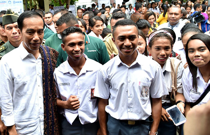 Presiden Joko Widodo menyerahkan bersama pelajar penerima Kartu Indonesia Pintar di Kota Kupang