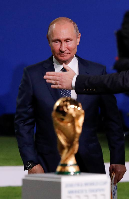 Russian President Vladimir Putin walks near the 2018 FIFA World Cup Winner's Trophy during the 68th FIFA Congress in Moscow, Russia June 13, 2018. REUTERS/Sergei Karpukhin